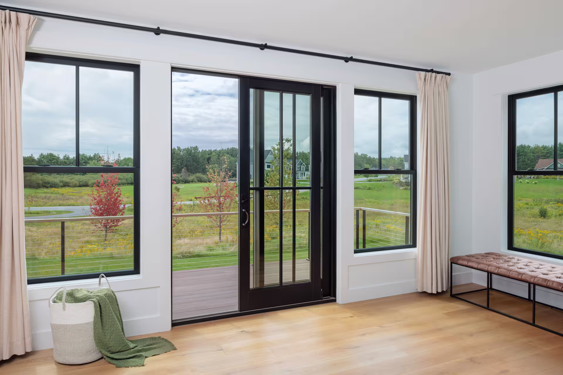 Living room with patio doors and windows